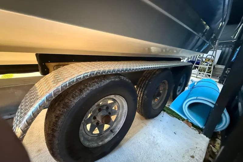 Slide: The Image of Trailer with diamond plate fender under a 2005 Formula 330 Sun Sport boat. - 13