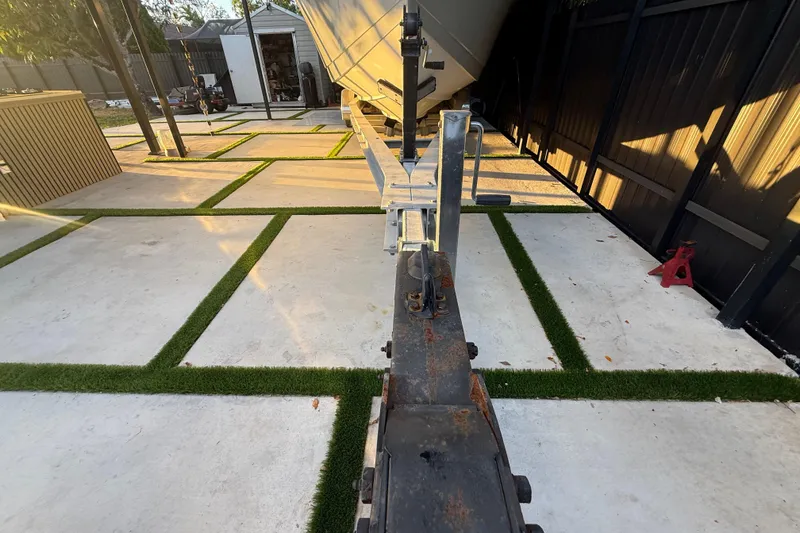 Slide: The Image of Trailer hitch of a 2005 Formula 330 Sun Sport boat in a modern driveway. - 16
