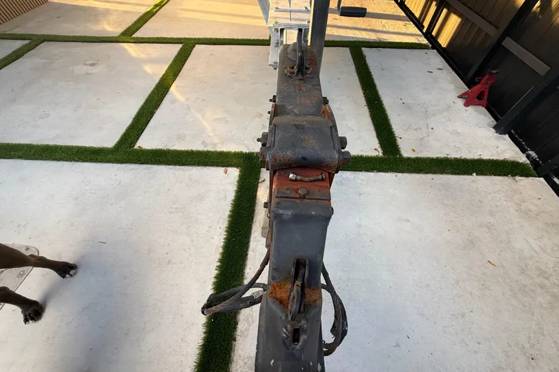 Slide: The Image of Rusty trailer hitch on concrete with grass strips, near Formula 330 Sun Sport, 2005. - 18