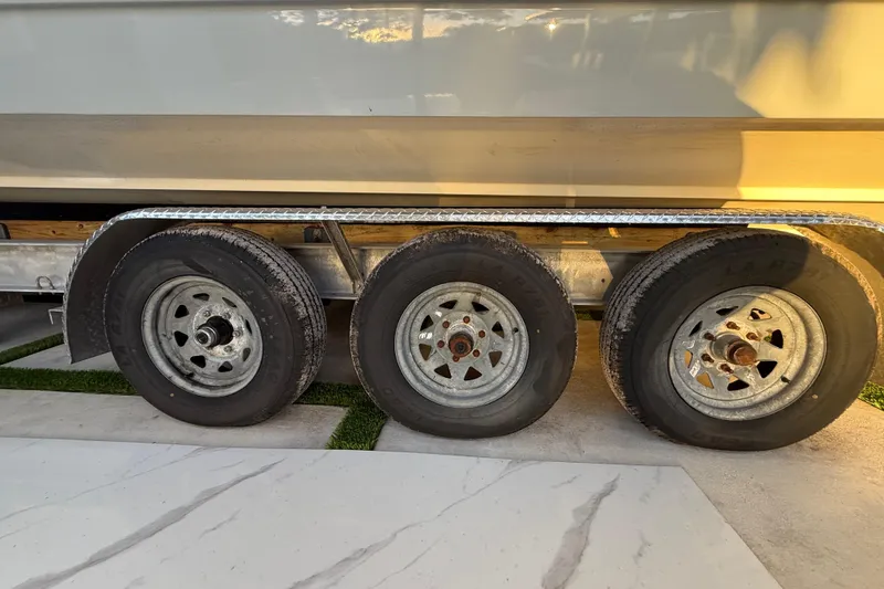 Slide: The Image of Trailer wheels of a 2005 Formula 330 Sun Sport boat in sunlight. - 19
