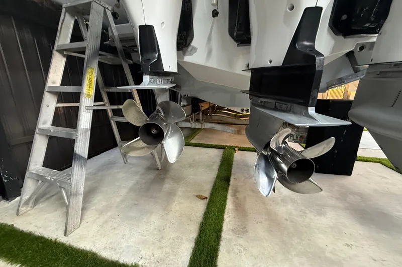 Slide: The Image of 2005 Formula 330 Sun Sport boat propellers and ladder in a garage setting. - 22