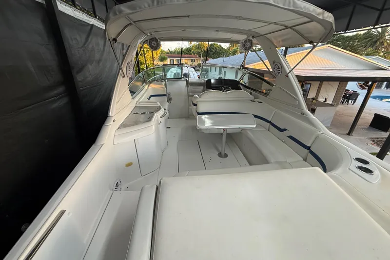 Slide: The Image of 2005 Formula 330 Sun Sport boat interior with seating and table under canopy. - 28