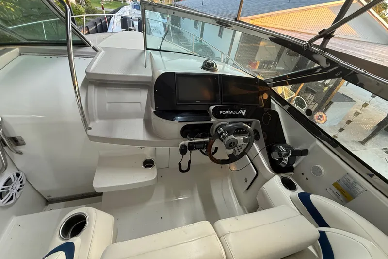 Slide: The Image of 2005 Formula 330 Sun Sport boat cockpit with steering wheel and control panel. - 29