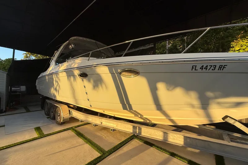 Slide: The Image of 2005 Formula 330 Sun Sport boat on trailer, parked in shaded area. - 3