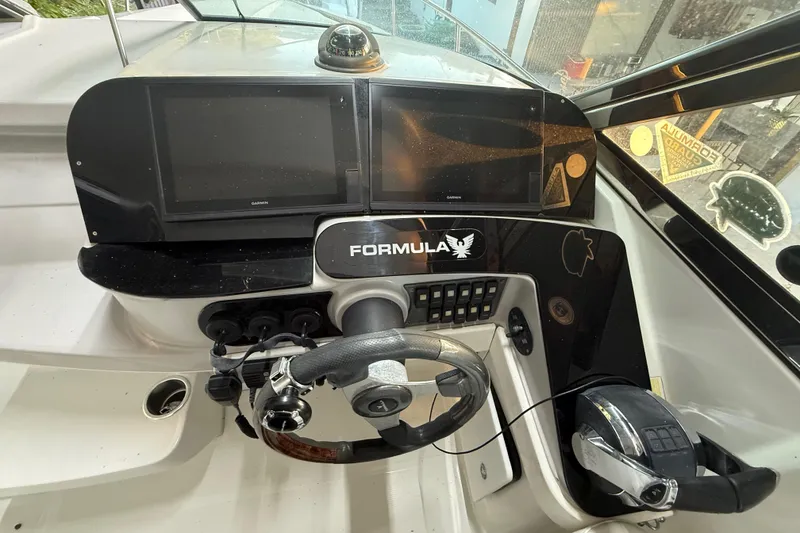Slide: The Image of Dashboard of a 2005 Formula 330 Sun Sport boat with steering wheel and controls. - 30