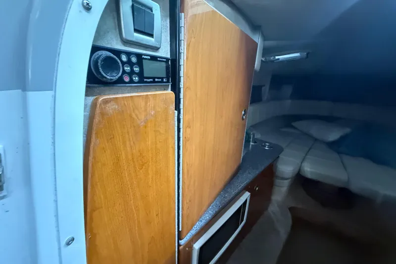 Slide: The Image of Interior of 2005 Formula 330 Sun Sport boat with wood cabinetry and seating area. - 33