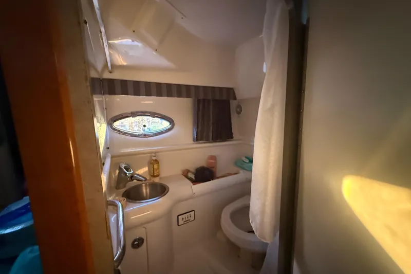 Slide: The Image of Compact bathroom inside 2005 Formula 330 Sun Sport boat, featuring sink and toilet. - 36