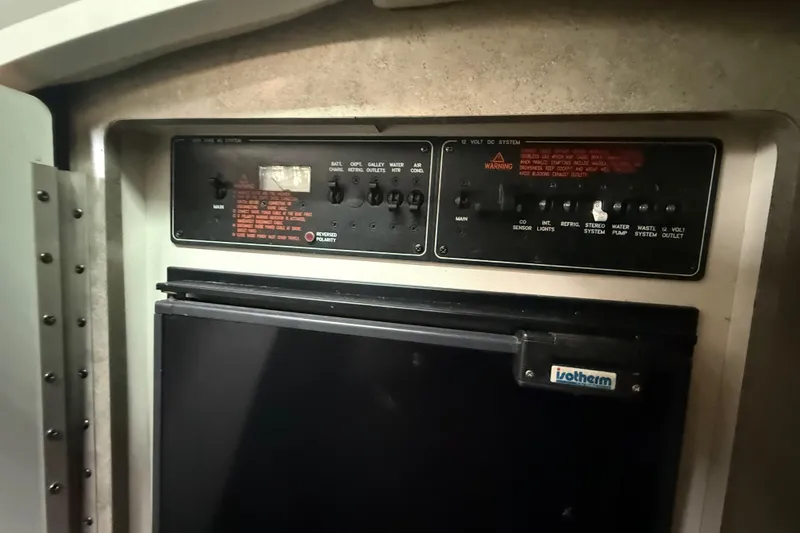 Slide: The Image of Control panel and refrigerator inside a 2005 Formula 330 Sun Sport boat. - 37