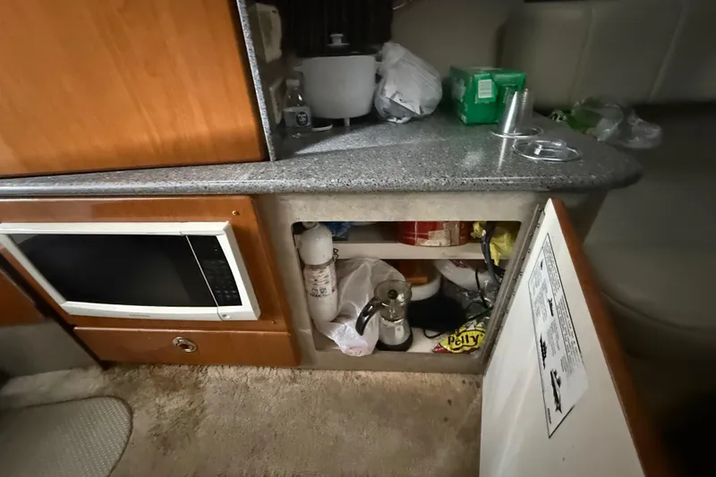 Slide: The Image of Interior of a 2005 Formula 330 Sun Sport boat with kitchenette and storage. - 39