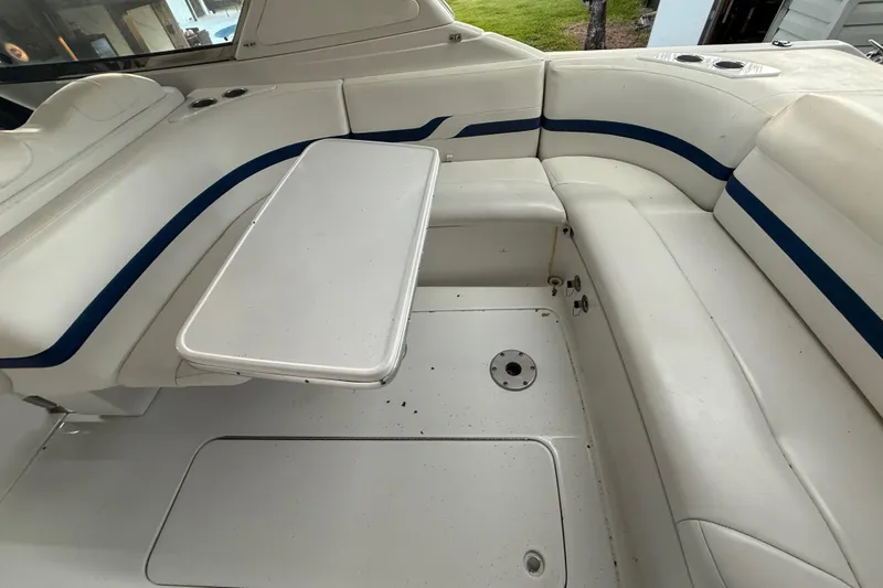 Slide: The Image of 2005 Formula 330 Sun Sport boat interior with white seating and table. - 43