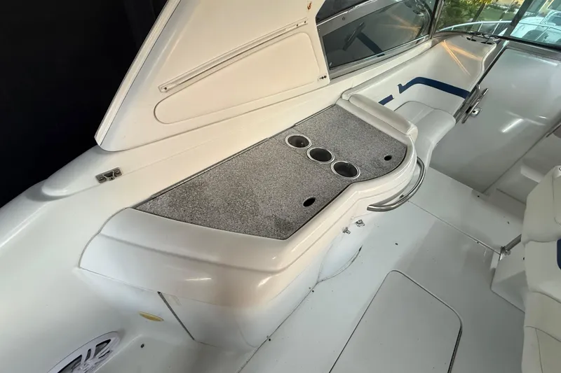 Slide: The Image of 2005 Formula 330 Sun Sport boat interior with sleek white seating and cup holders. - 44