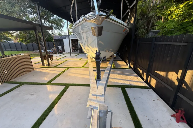 Slide: The Image of 2005 Formula 330 Sun Sport boat on trailer in modern backyard setting. - 7