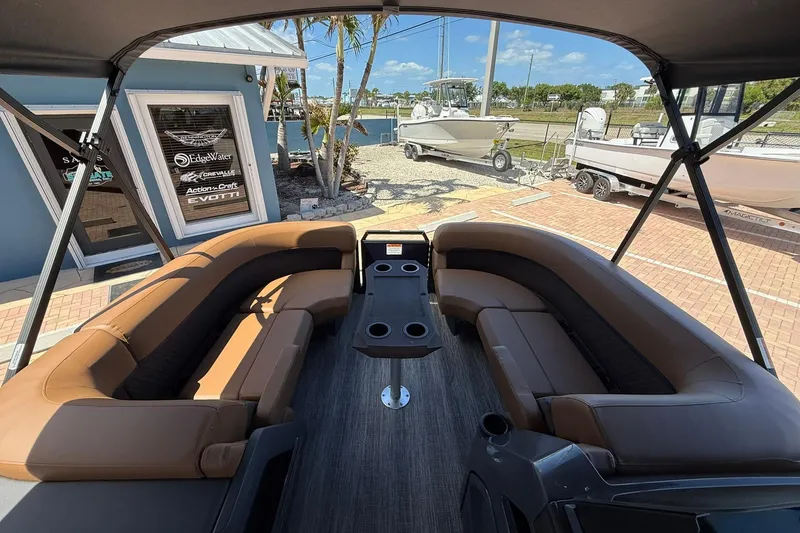 Slide: The Image of 2026 Bennington 22 M Quad Bench boat interior with luxurious seating and cup holders. - 13