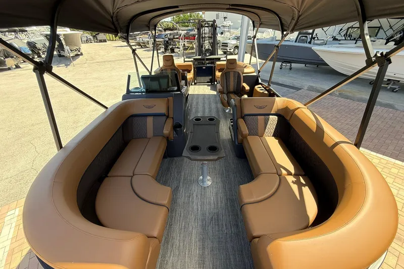 Slide: The Image of 2026 Bennington 22 M Quad Bench pontoon boat with luxurious seating and canopy. - 14