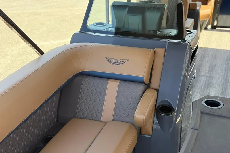 Slide: The Image of 2026 Bennington 22 M Quad Bench with luxurious tan and gray seating. - 15