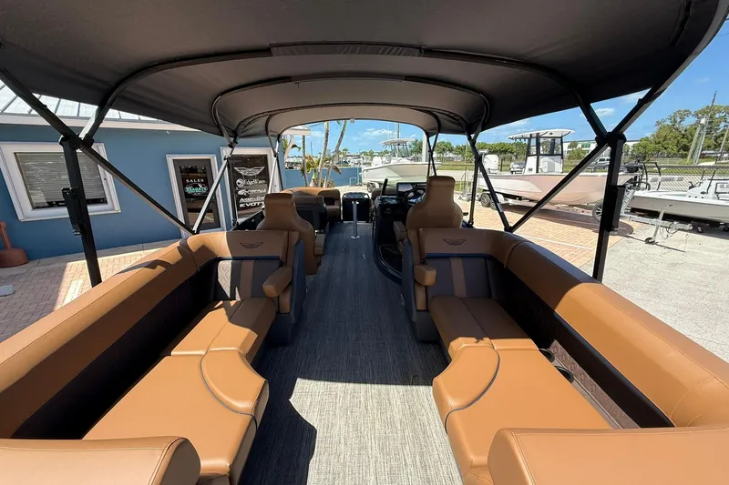 Slide: The Image of 2026 Bennington 22 M Quad Bench pontoon boat with luxurious seating and canopy. - 5
