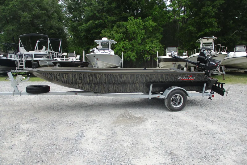 The Image of 2026 Gator Tail 1854 Extreme boat on trailer, surrounded by other boats. - 0