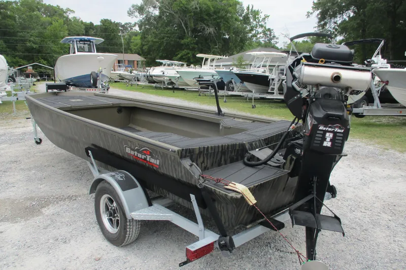 Slide: The Image of 2026 Gator Tail 1854 Extreme boat on trailer, surrounded by other boats. - 4