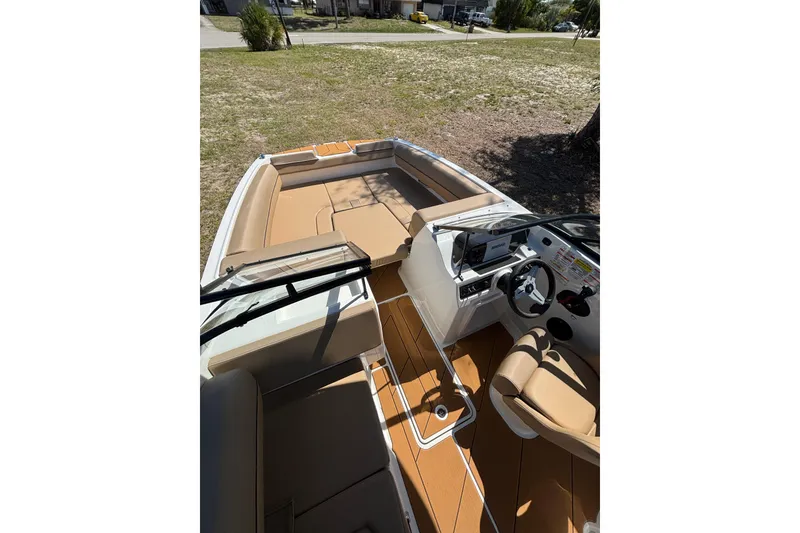 Slide: The Image of 2026 Bayliner D20 boat interior with tan seating and modern dashboard. - 10