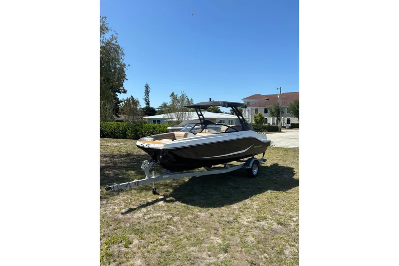 Slide: The Image of 2026 Bayliner D20 boat on trailer, parked outdoors under clear blue sky. - 3