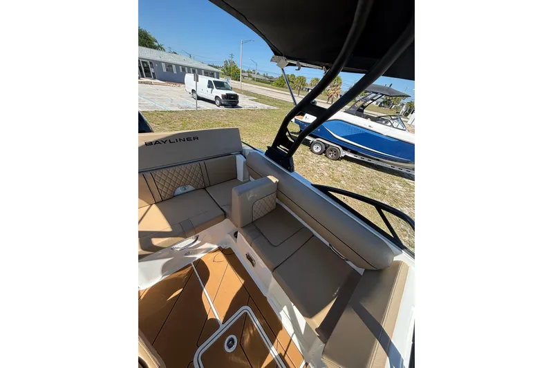Slide: The Image of 2026 Bayliner D20 boat interior with tan seating and sleek design. - 8