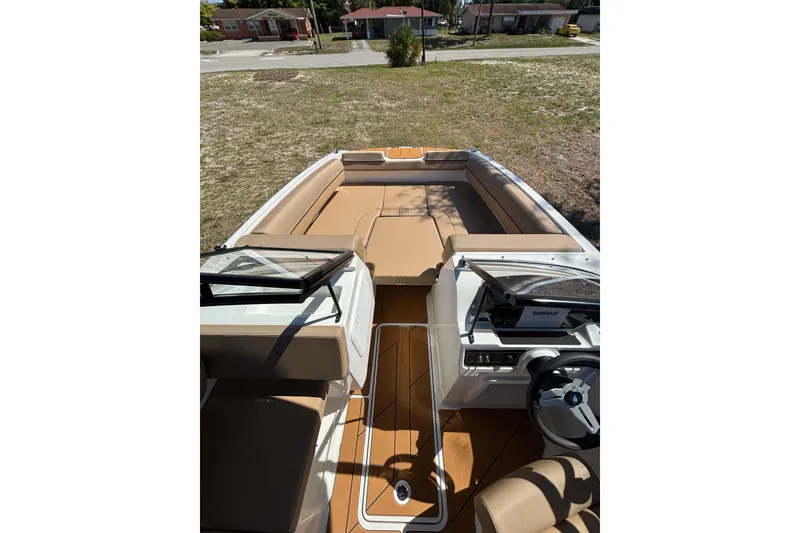 Slide: The Image of 2026 Bayliner D20 boat interior with tan seating and modern dashboard. - 9