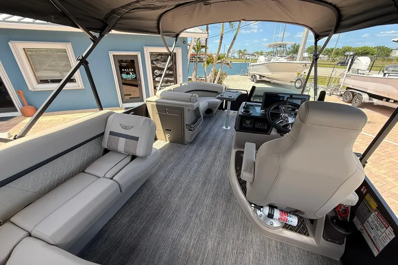 Slide: The Image of 2026 Bennington 22 M Swingback pontoon boat interior with plush seating and modern helm. - 10