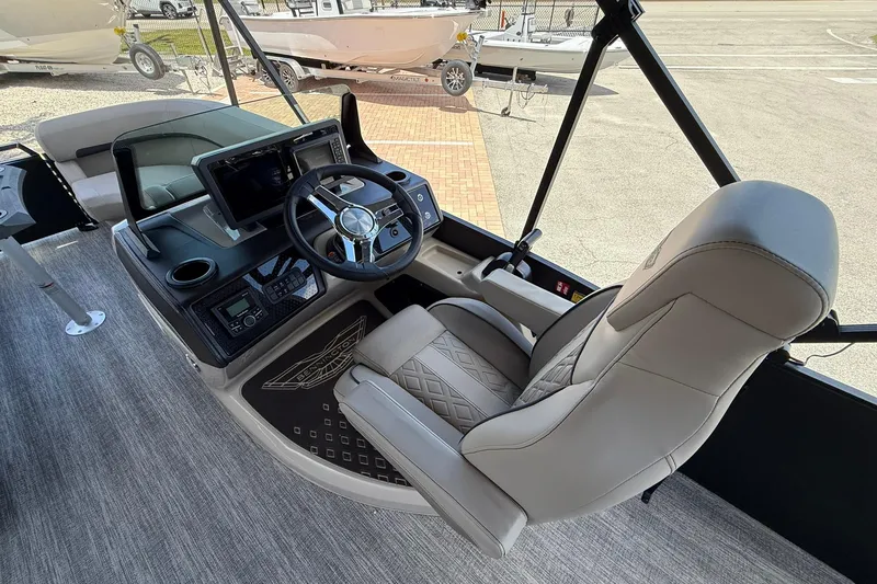 Slide: The Image of Captain's seat and helm of 2026 Bennington 22 M Swingback boat, featuring modern controls. - 12