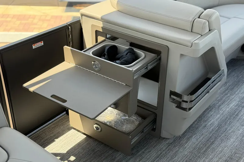 Slide: The Image of 2026 Bennington 22 M Swingback boat interior with open storage compartments and seating. - 15