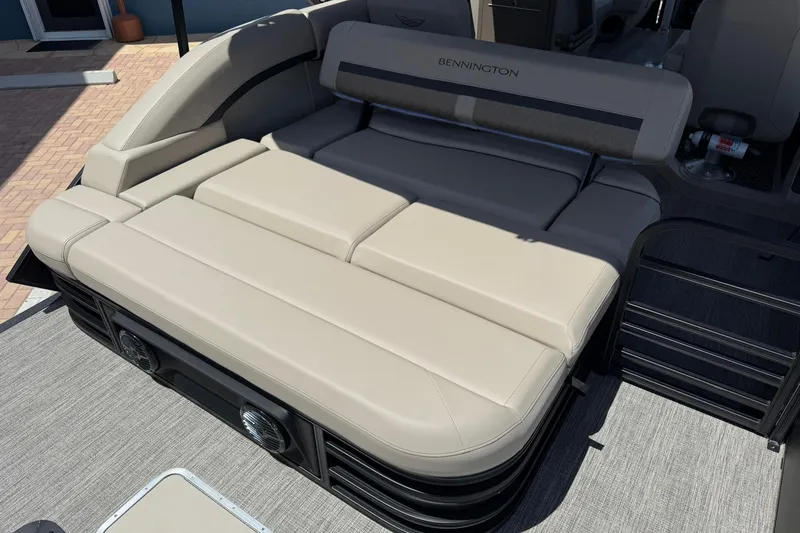 Slide: The Image of 2026 Bennington 22 M Swingback boat interior with beige seating and speaker system. - 6