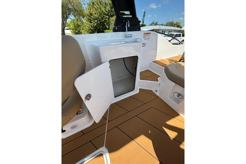 Slide: The Image of 2026 Bayliner D22 boat interior with open storage compartment and seating. - 15