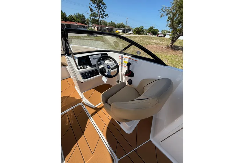 Slide: The Image of 2026 Bayliner D22 boat cockpit with steering wheel and comfortable seating. - 16