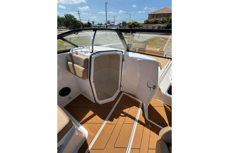 Slide: The Image of Interior view of 2026 Bayliner D22 boat with open cabin door and seating. - 17