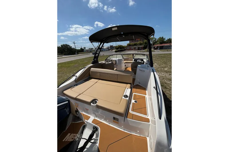 Slide: The Image of 2026 Bayliner D22 boat with tan seating and sleek design under a sunny sky. - 20