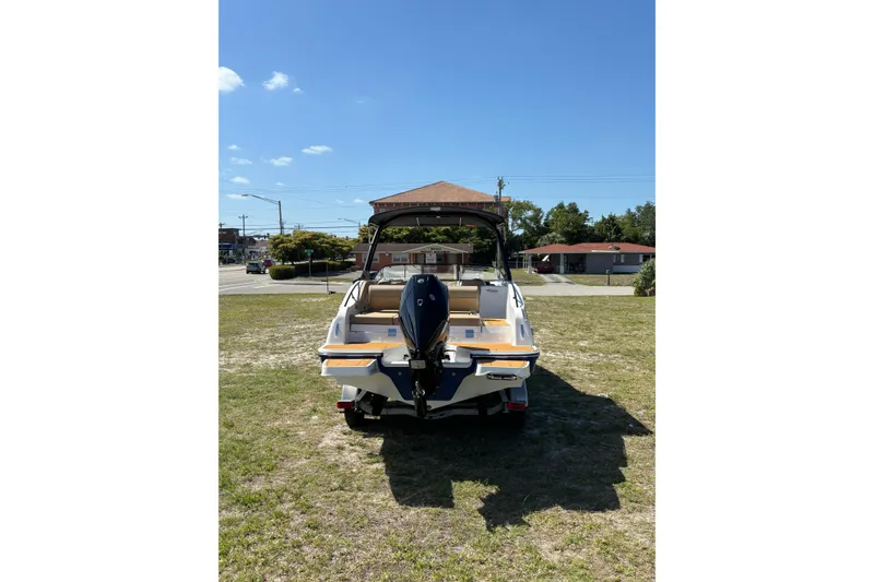 Slide: The Image of 2026 Bayliner D22 boat on grass, rear view with outboard motor. - 3