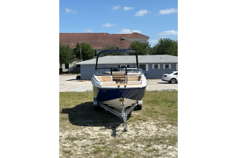 Slide: The Image of 2026 Bayliner D22 boat on trailer, parked outdoors under clear blue sky. - 8