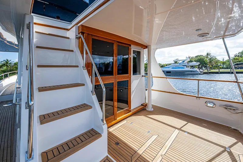 Slide: The Image of Grand Banks 42 Europa 2002 yacht deck with wooden stairs and waterfront view. - 10