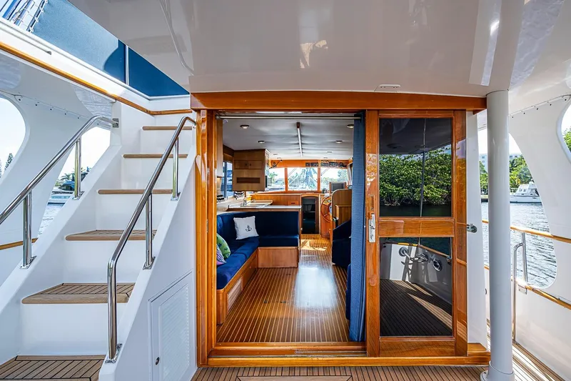 Slide: The Image of Interior view of 2002 Grand Banks 42 Europa yacht with wooden finishes and blue seating. - 12