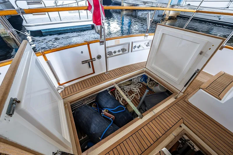 Slide: The Image of Open storage compartment on 2002 Grand Banks 42 Europa yacht deck, showing ropes and equipment. - 14