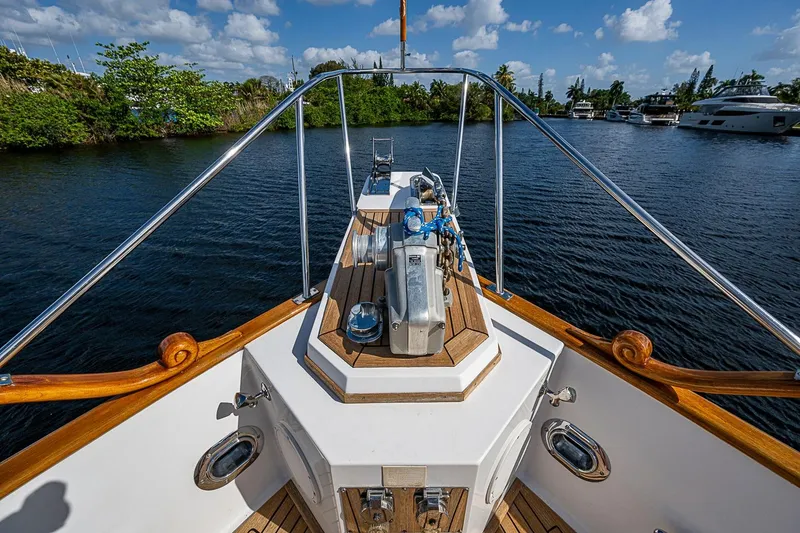 Slide: The Image of Bow view of 2002 Grand Banks 42 Europa yacht on calm water. - 18