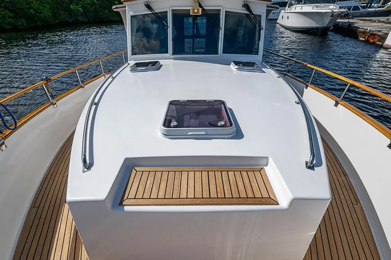 Slide: The Image of 2002 Grand Banks 42 Europa yacht deck with teak accents and water view. - 20