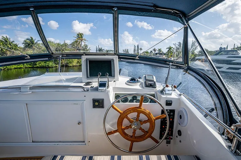 Slide: The Image of Cockpit view of 2002 Grand Banks 42 Europa yacht with steering wheel and navigation equipment. - 23
