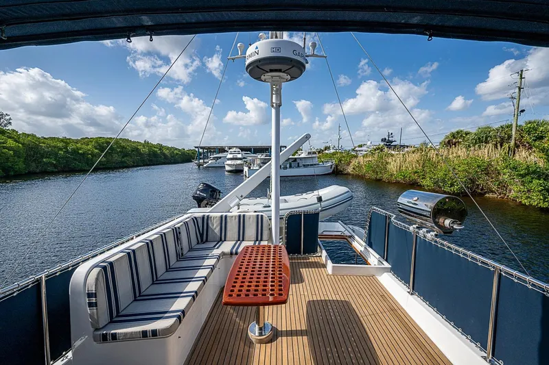 Slide: The Image of Deck view of 2002 Grand Banks 42 Europa yacht with seating and scenic waterway. - 25