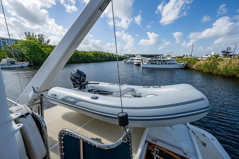 Slide: The Image of 2002 Grand Banks 42 Europa yacht with inflatable boat on deck, docked on a sunny day. - 27