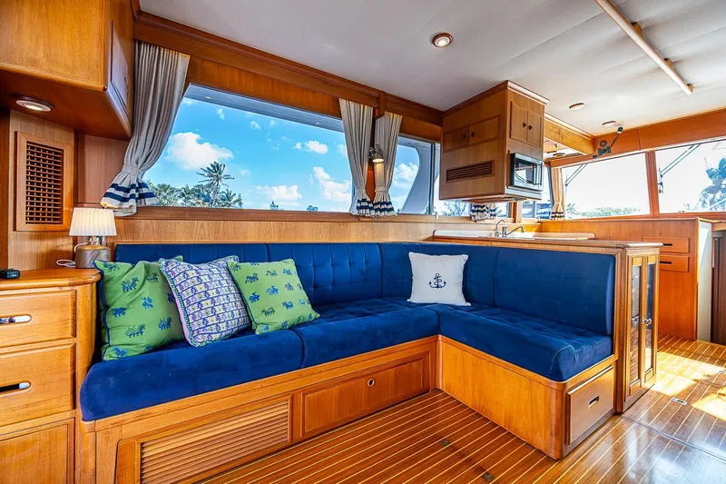 Slide: The Image of Luxurious interior of 2002 Grand Banks 42 Europa yacht with blue seating and wooden finishes. - 30