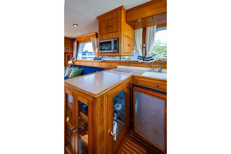 Slide: The Image of Luxurious 2002 Grand Banks 42 Europa yacht interior with wooden cabinetry and modern amenities. - 33