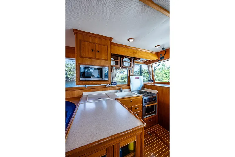 Slide: The Image of Galley kitchen in 2002 Grand Banks 42 Europa yacht with wood cabinetry and modern appliances. - 35