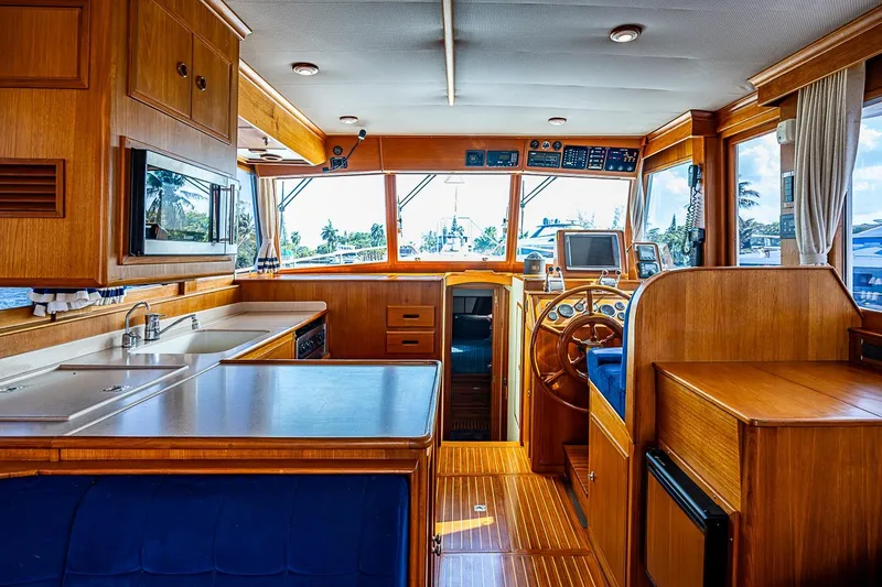 Slide: The Image of Interior of 2002 Grand Banks 42 Europa yacht with wooden cabinetry and helm station. - 36