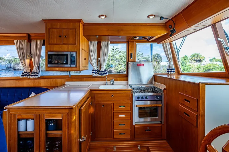 Slide: The Image of Luxurious wooden interior of 2002 Grand Banks 42 Europa yacht kitchen with modern appliances. - 37
