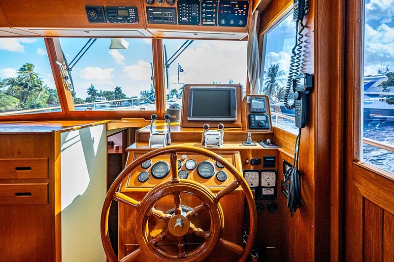 Slide: The Image of Helm of 2002 Grand Banks 42 Europa yacht with wooden steering wheel and navigation instruments. - 40